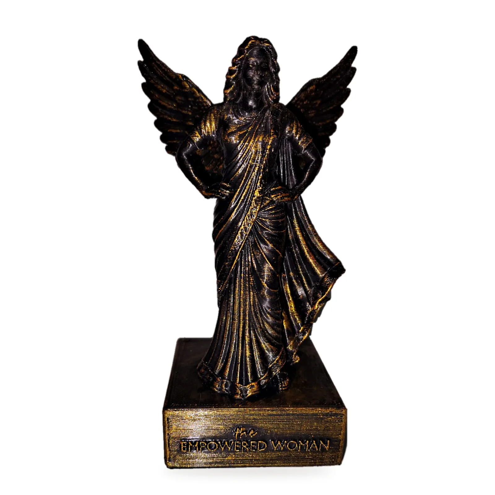 The Empowered Woman statue: a winged woman in a draped saree, hands on hips, antique gold on black, on a base engraved "the Empowered Woman"
